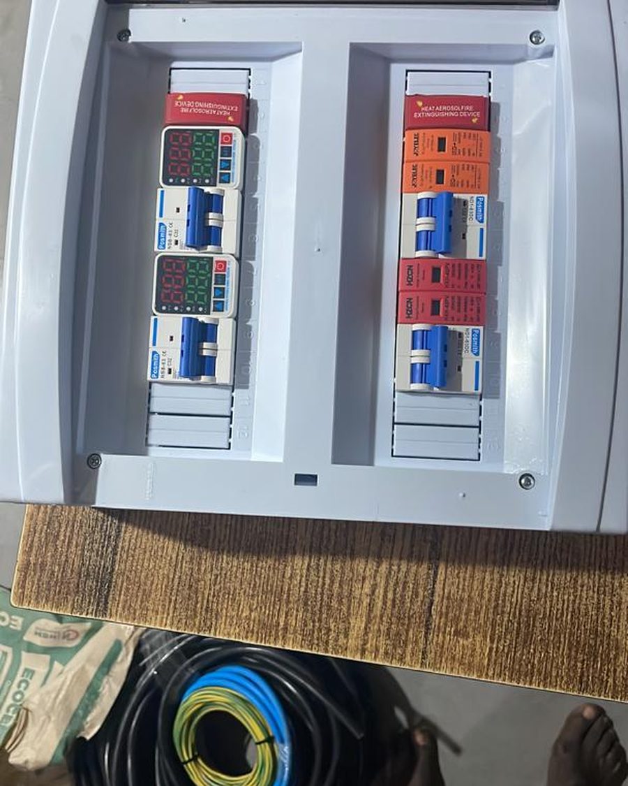 An opened distribution board with digital meters, breakers and surge protection fitted.